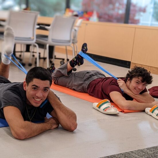 Students in a yoga pose in the wellbeing lab.