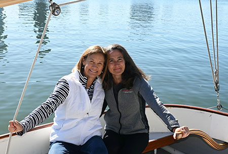 Carrie and Jen on a sailboat on the Charles River