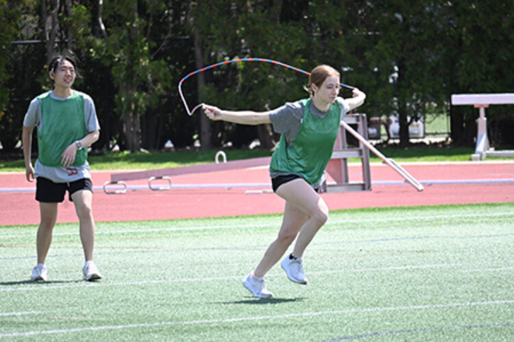 Student jumping rope on a playing field
