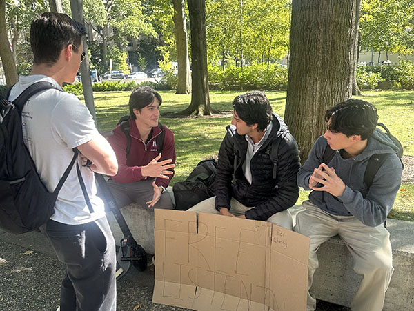 A group of students with a sign that says free listening
