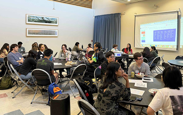 Group of students sitting at tables in the dining room of building W11